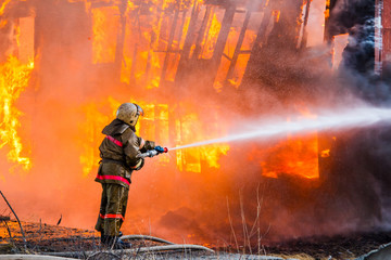 Naklejka premium Fireman extinguishes a fire