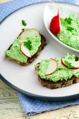 canape with cottage cheese, greens and a garden radish.