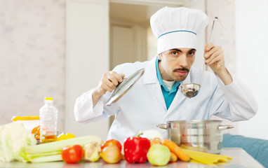 Caucasian  cook tasting soup   from pa