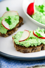 canape with cottage cheese, greens and a garden radish.