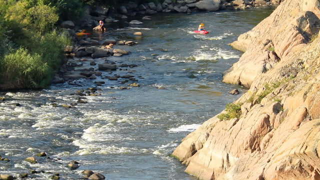 kayak rowers train pass rapids on the river