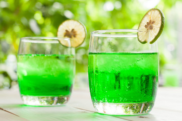 Cocktail with fresh wet lemons on white background
