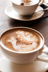 Latte' Art Coffee,Cup of latte coffee on wooden background