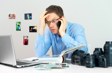 Angry photographer discussing photos with client.