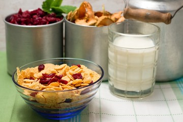 Blue glass bowl with cornflakes in front of old cups