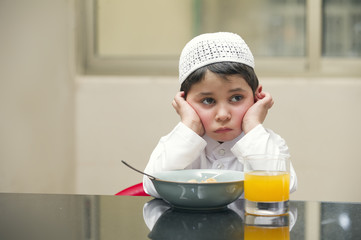 Arabian kid having breakfast of cornflakes & orange juice © Ramzi