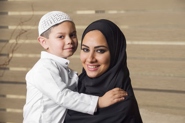 Arabian mother holding her son