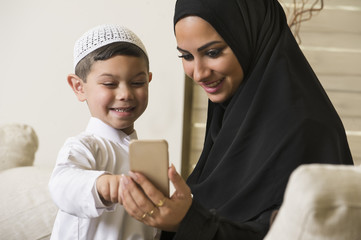 Arabian family, Arabian mother and son using mobile phone