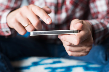 Close up of a man using mobile smart phone