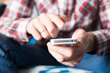 Close up of a man using mobile smart phone