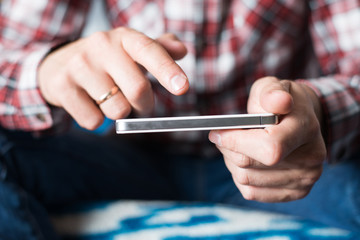 Close up of a man using mobile smart phone
