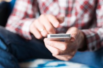 Close up of a man using mobile smart phone