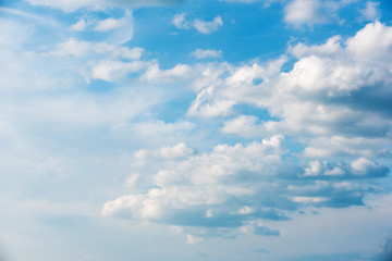 Beautiful azure sky with slowly moving fluffy clouds