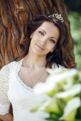Beautiful bride outdoors in a forest.