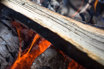 Burning smoldering firewood in the fireplace
