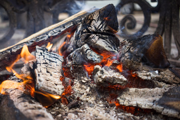 Burning smoldering firewood in the fireplace