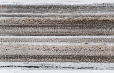 sludgy snow texture with skid marks on the street