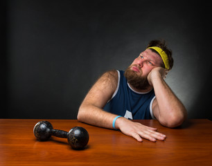 Dreaming man and a dumbbell 