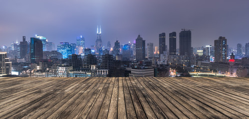 wooden platform and lights of night city