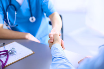 Doctor shakes hands with a patient isolated on white background