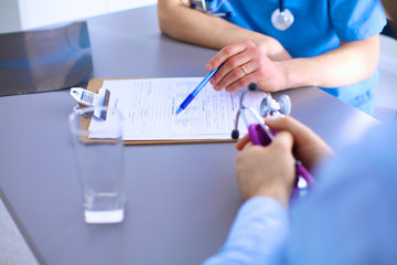 Doctor and patient sitting on the desk