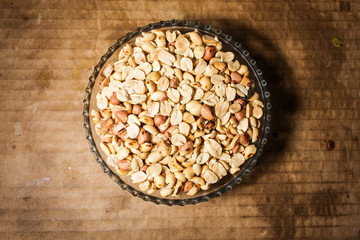 peanuts in bowl on vintage background
