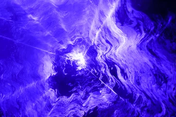 Foto op Plexiglas Licht en schaduw Blue spotlight shining through smoke