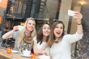 Women taking a selfie in a cafe in Copenhagen