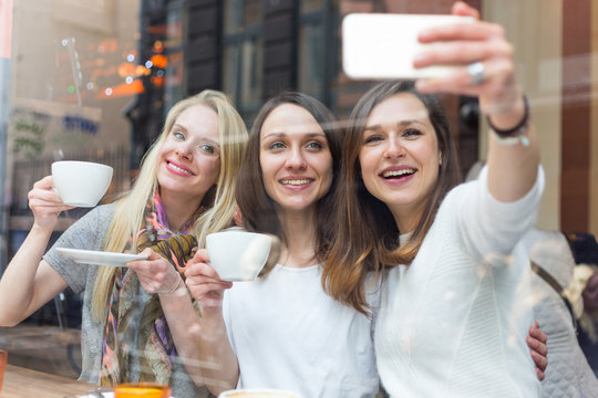 Women taking a selfie in a cafe in Copenhagen