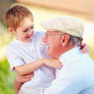 portrait of happy grandpa and grandson having fun outdoors