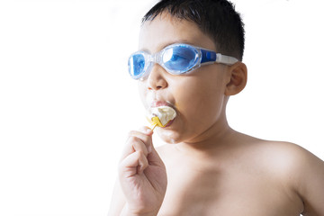 Male child enjoy ice cream in studio