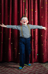 Boy Dressed as Clown Performing on Stage