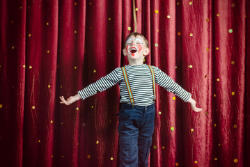 Boy Dressed as Clown Performing on Stage