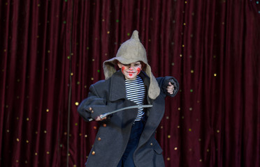 Boy Wearing Make Up and Large Coat with Toy Sword