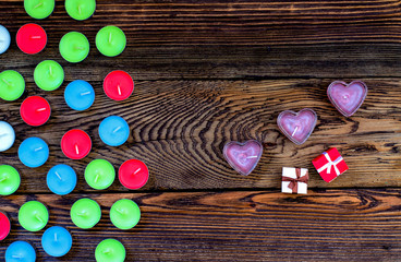 Colorful Tealight Candles on Wooden Background