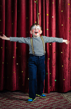 Boy Dressed as Clown Performing on Stage
