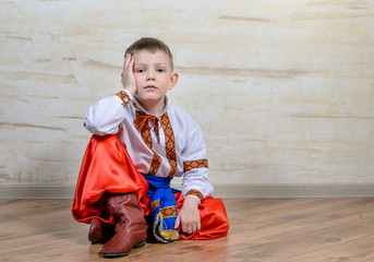 Inquiring boy with traditional folk costume