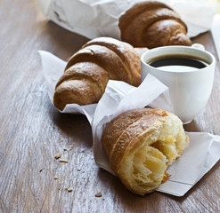 Fresh croissants with cup of coffee for breakfast.