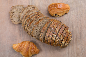 Brown slices of bread isolated over wooden brown  background