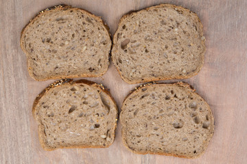 Brown slices of bread isolated over wooden brown  background