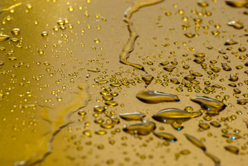Water drops in detail on gold plate