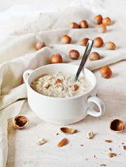 Oatmeal porridge in a bowl with hazelnuts