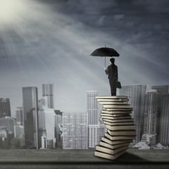 Woman standing on a pile of books