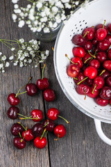 Fresh clean organic ripe cherries in colander