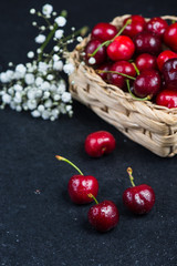 Fresh ripe organic cherries on black border  background