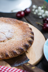 Homemade cherry pie served on rustic table