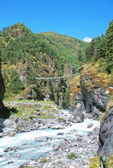 Fototapeta na wymiar Rope bridge on the way to Namche Bazaar village in Himalayas