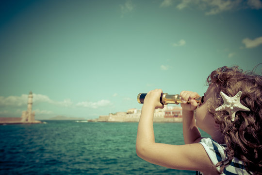 Sailor kid looking through the binoculars