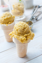 Homemade mango ice cream on vintage light white wooden