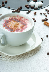 Cappuccino coffee and sugar cubes on a vinyl plate